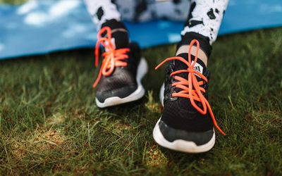 Close-up of athletic shoes on a yoga mat.